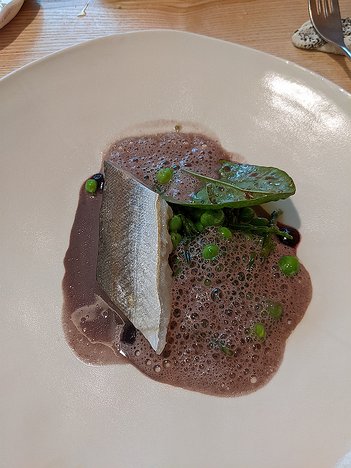 20230427_PXL112845773_Pixel3a-JEB third couse: Hake cooked in seaweed butter with a blueberry sauce, peas and samphire (salicorne)